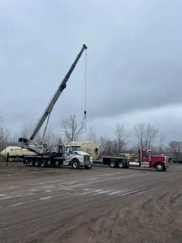 Heavy machinery lifting concrete structures at a construction site