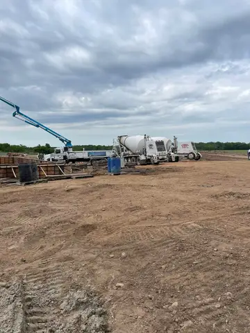 Concrete pouring into forms at a construction site in Gilman